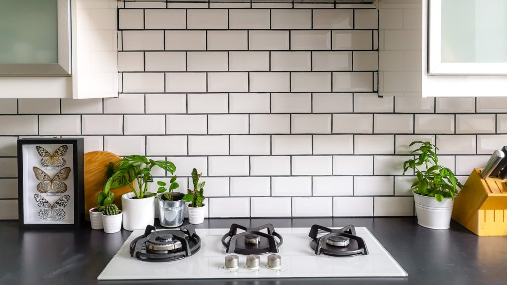 Black,And,White,Subway,Tiled,Kitchen,With,Numerous,Plants,And