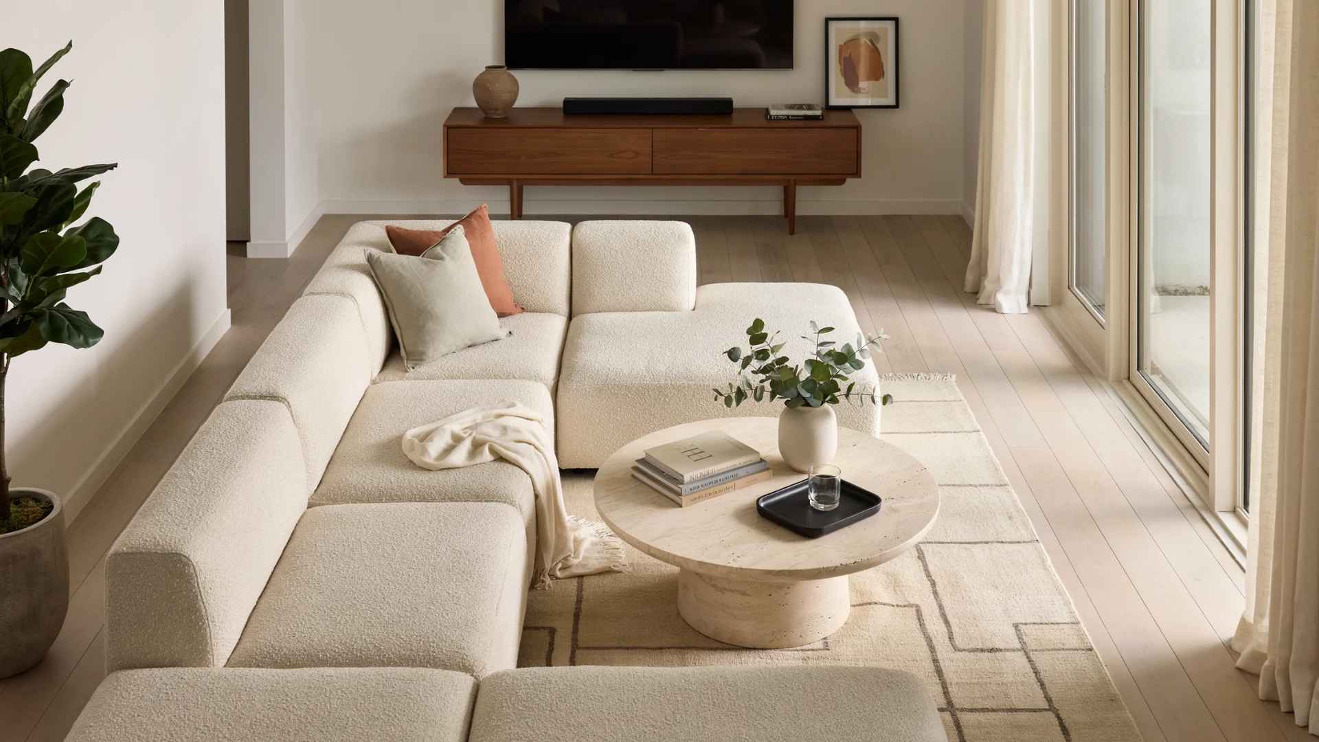 Living room with a corner sofa arranged to maximize seating and floor space.