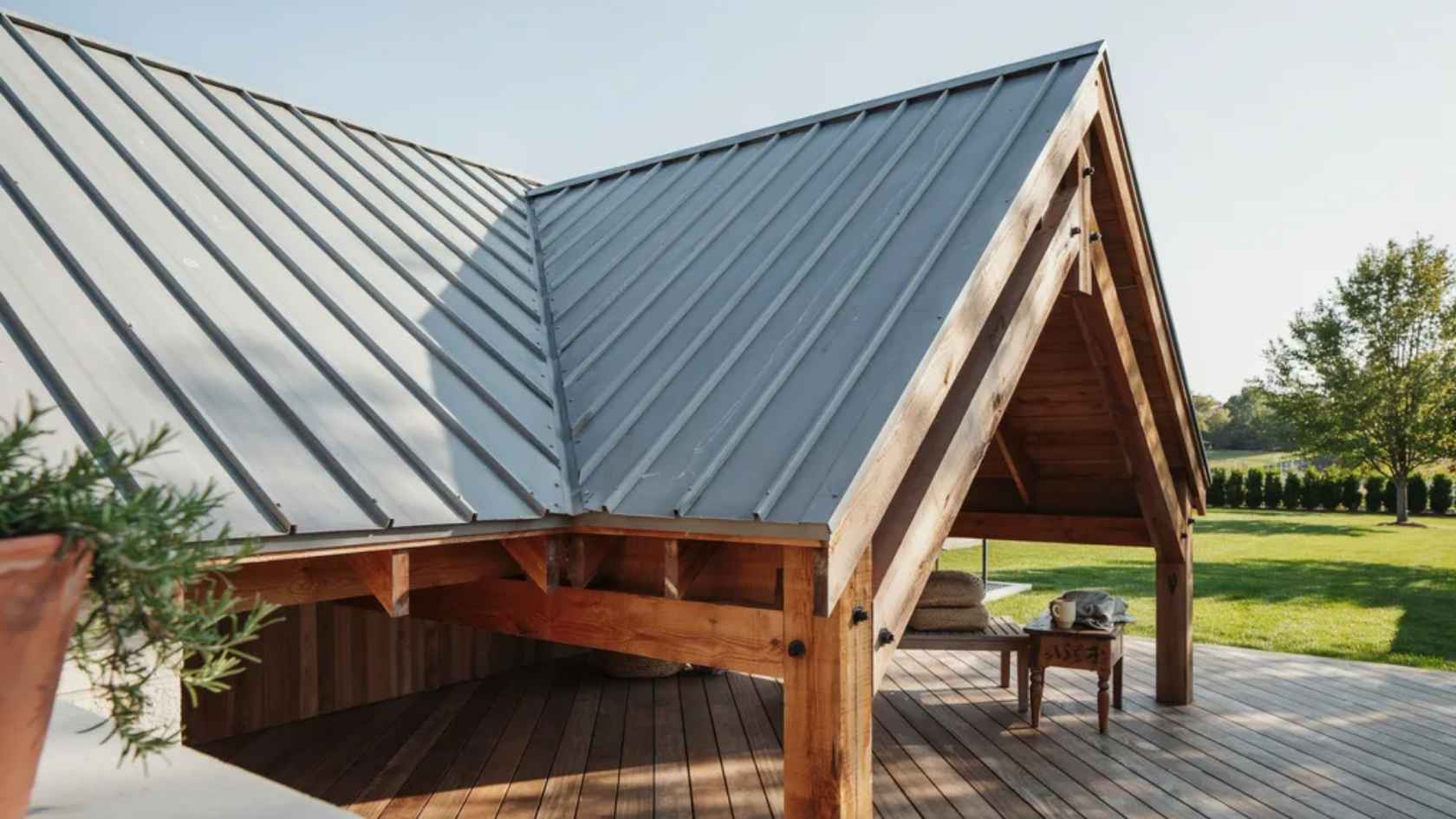 Covered deck featuring corrugated metal roofing and exposed wood frame construction