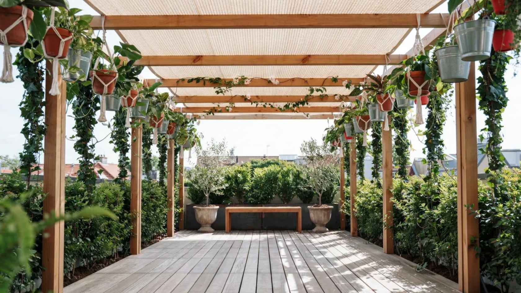 DIY living roof canopy with shade cloth and hanging planters creating natural deck shade