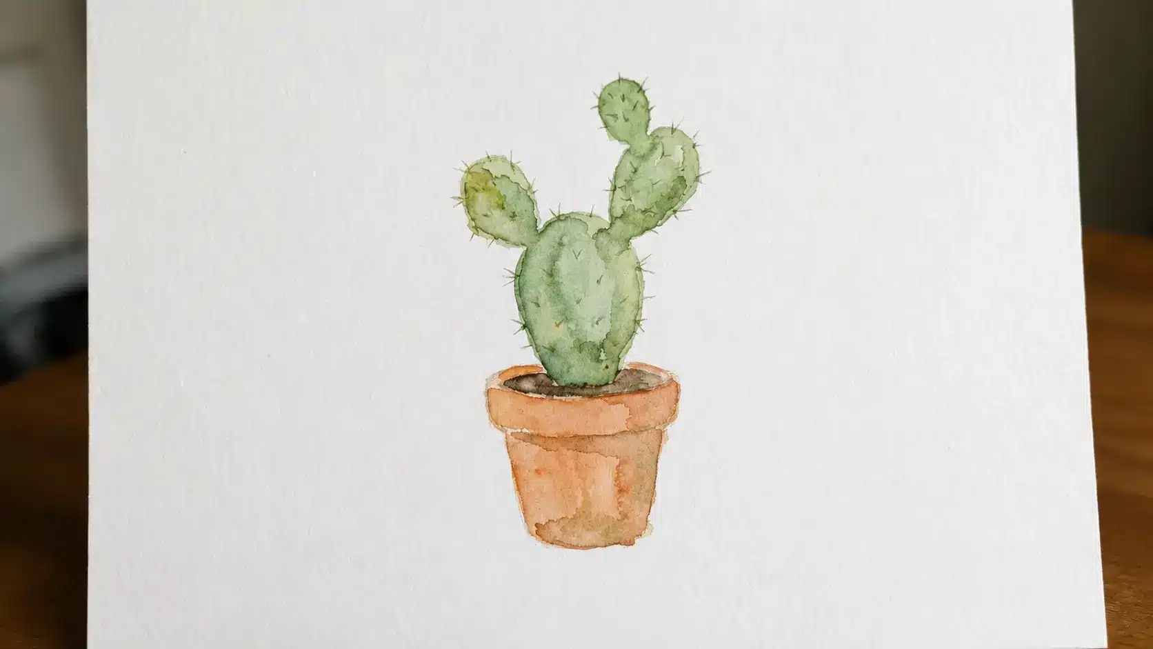 Easy watercolor cactus painting in a small terracotta pot