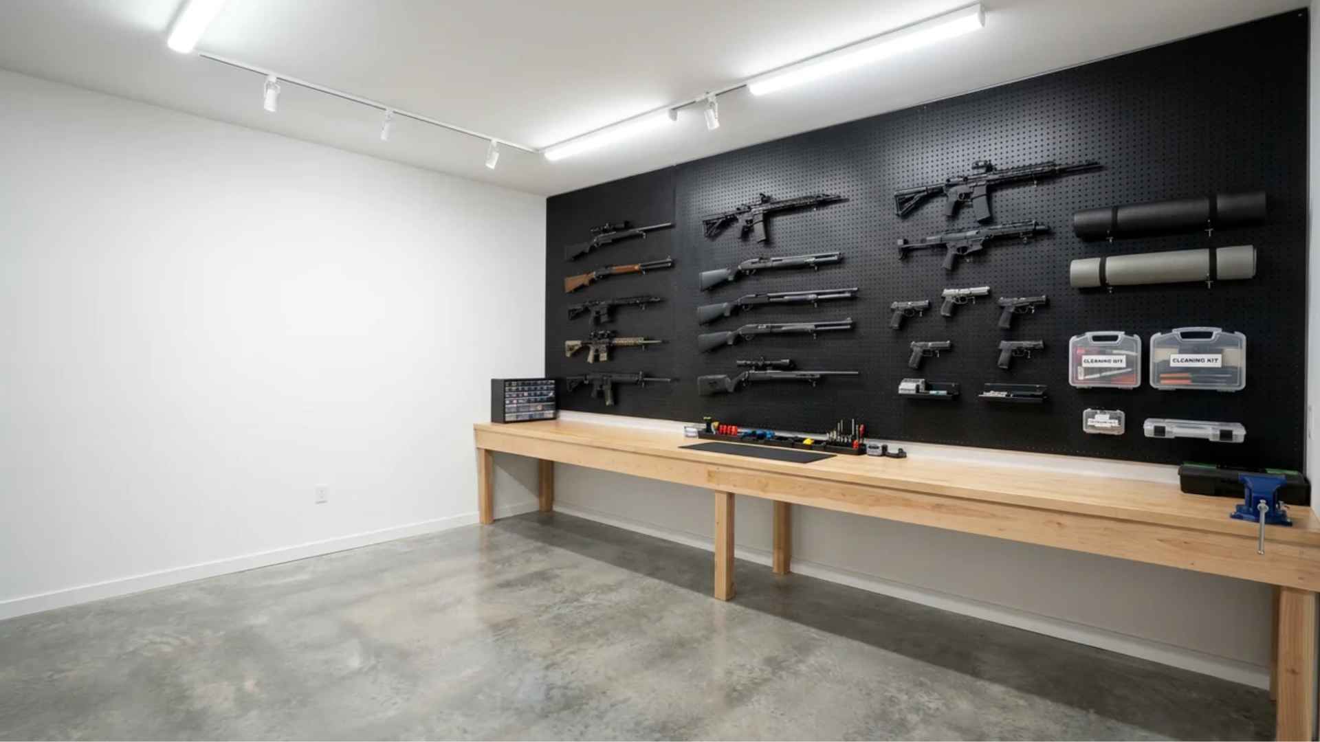 Full pegboard wall with neatly arranged firearms, tools, and accessories in a clutter-free setup