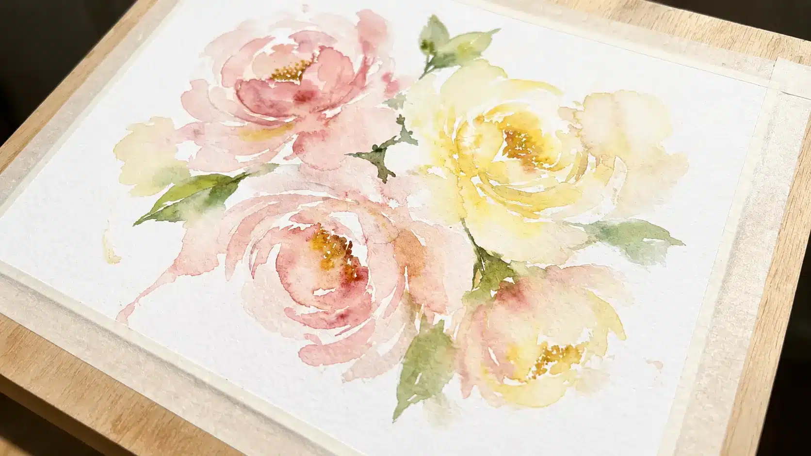 Simple watercolor flowers with soft blended petals on white paper