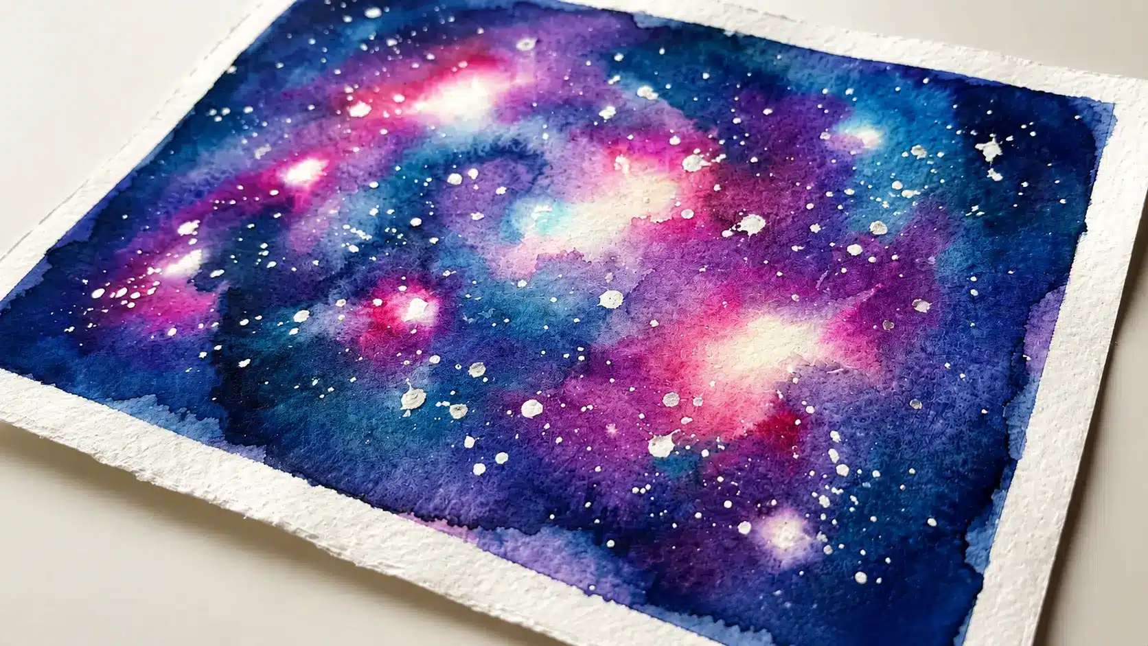 Watercolor galaxy painting with soft purple and blue tones and scattered stars