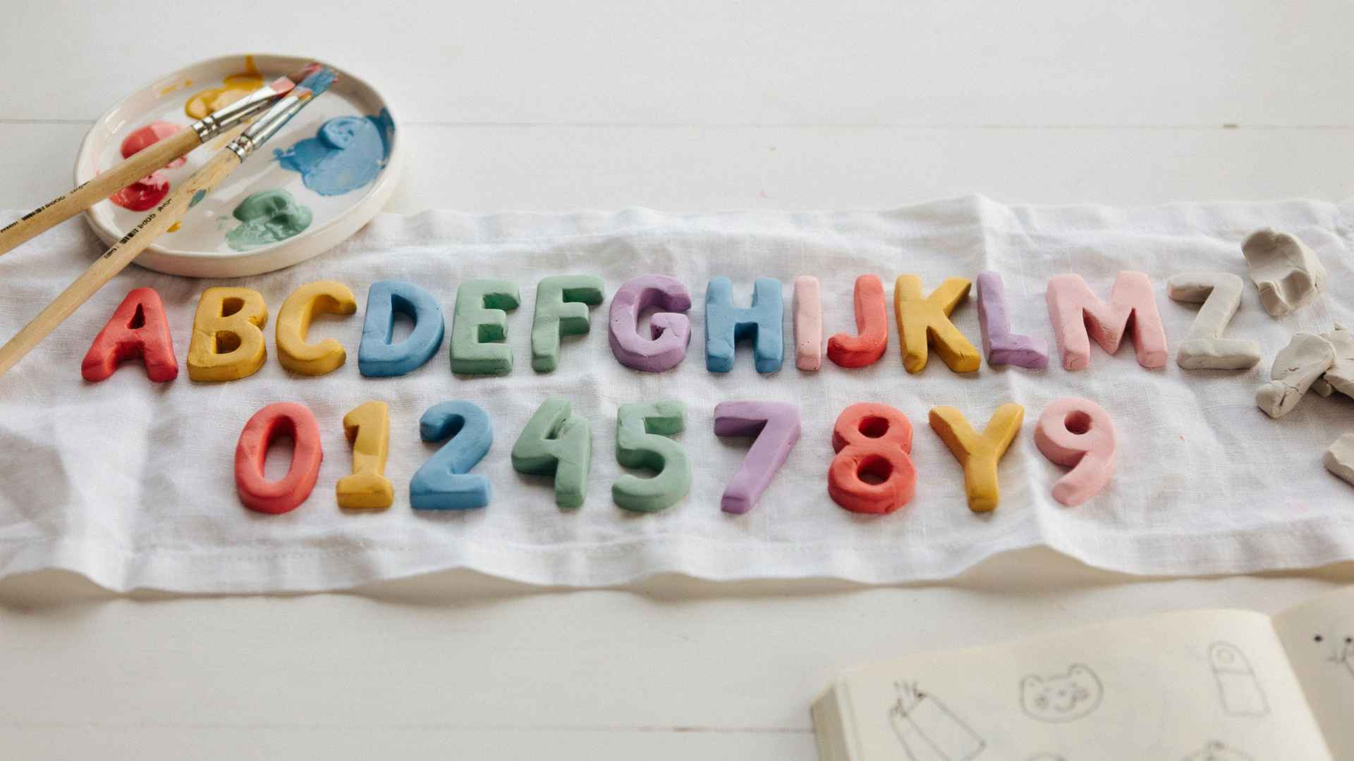 Painted clay alphabet and number learning pieces