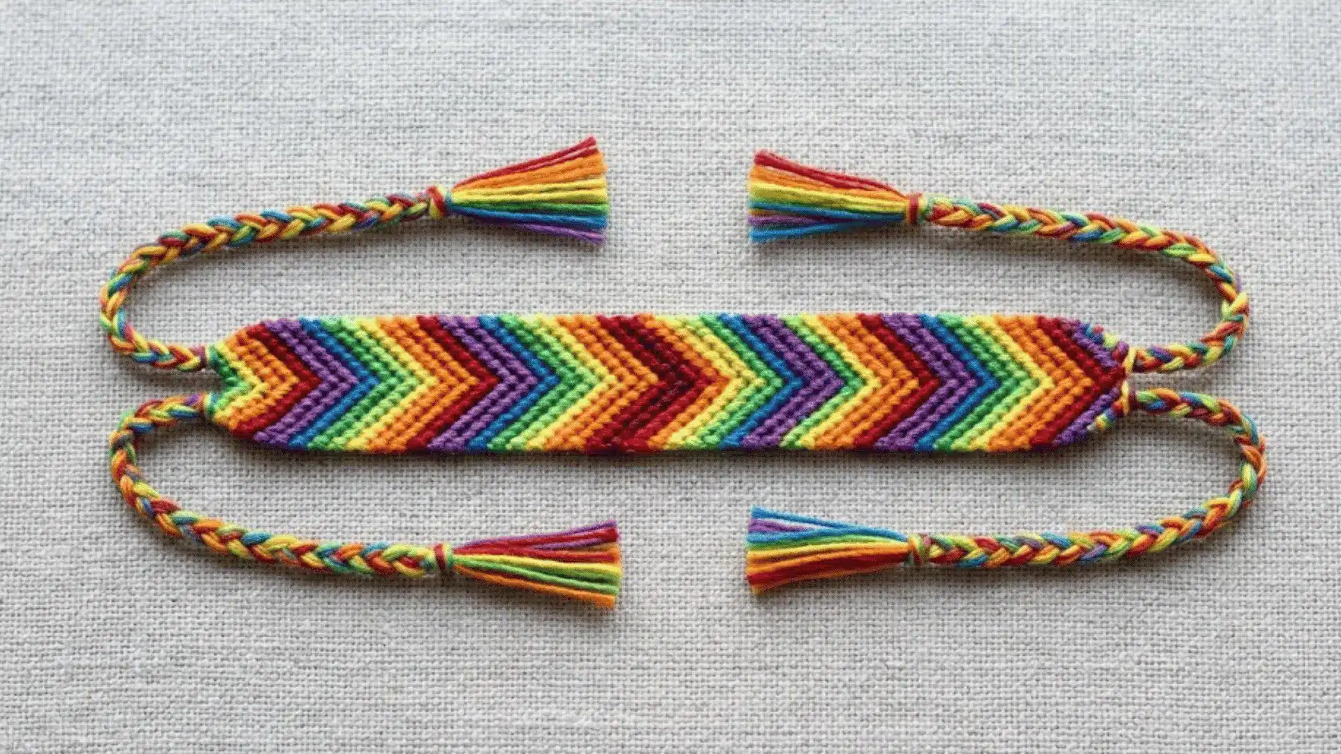 Chevron friendship bracelet with colorful V-shaped stripe pattern.