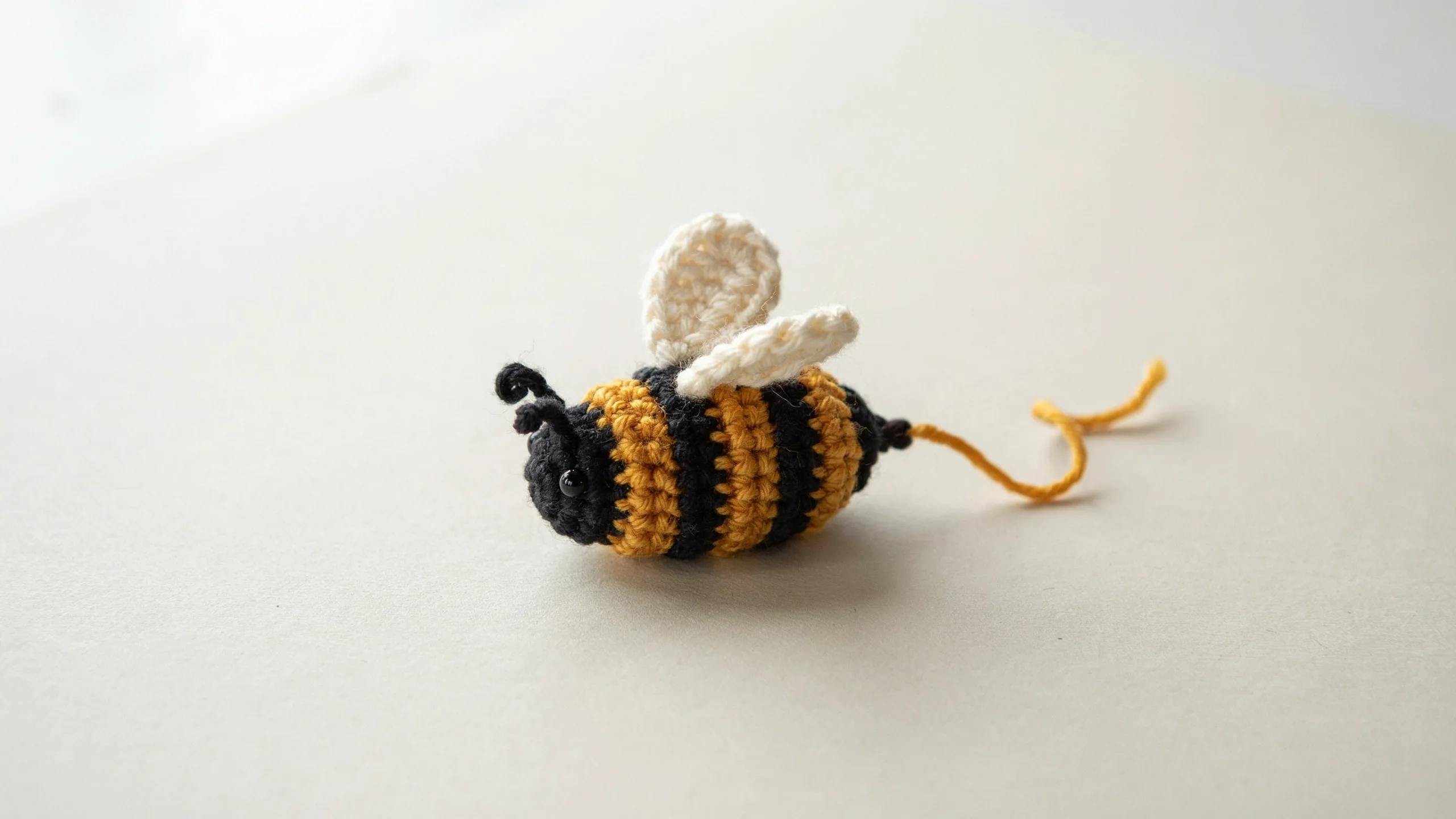 Crochet bee with yellow black stripes small wings and stinger centered