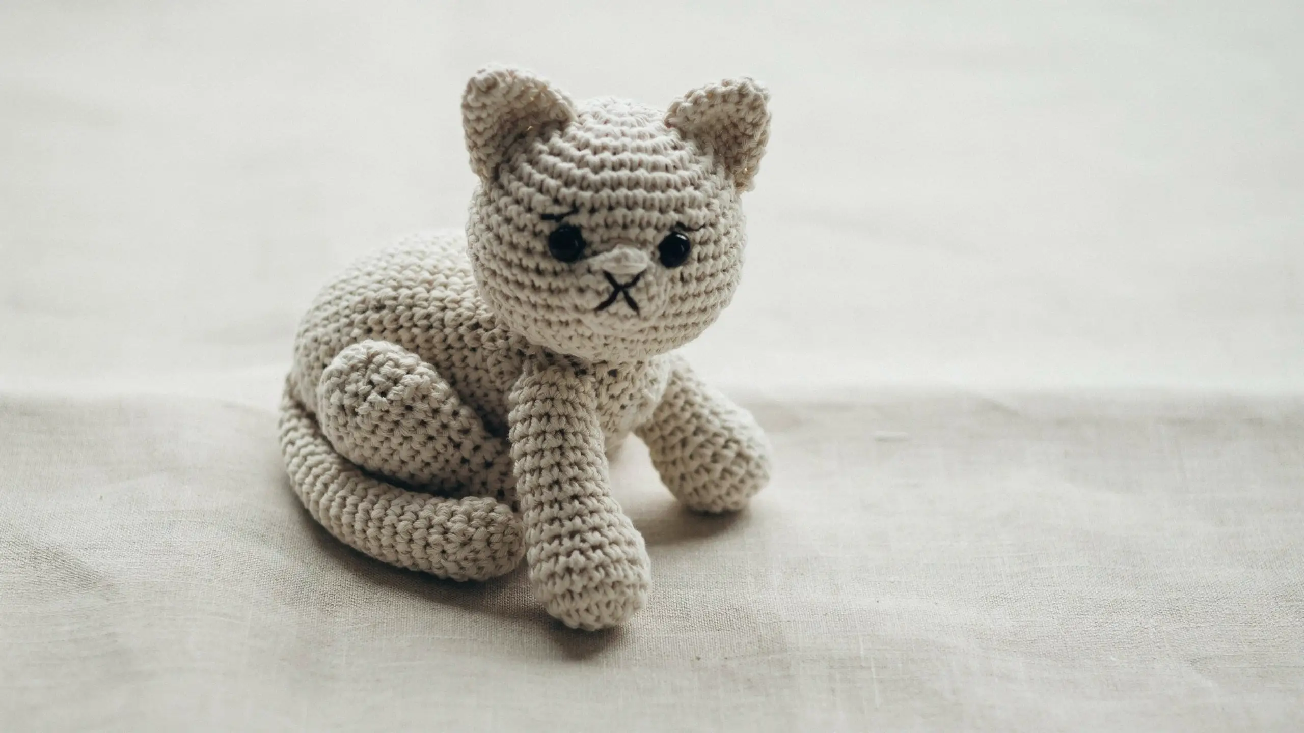 Crochet cat with pointed ears and wrapped tail centered