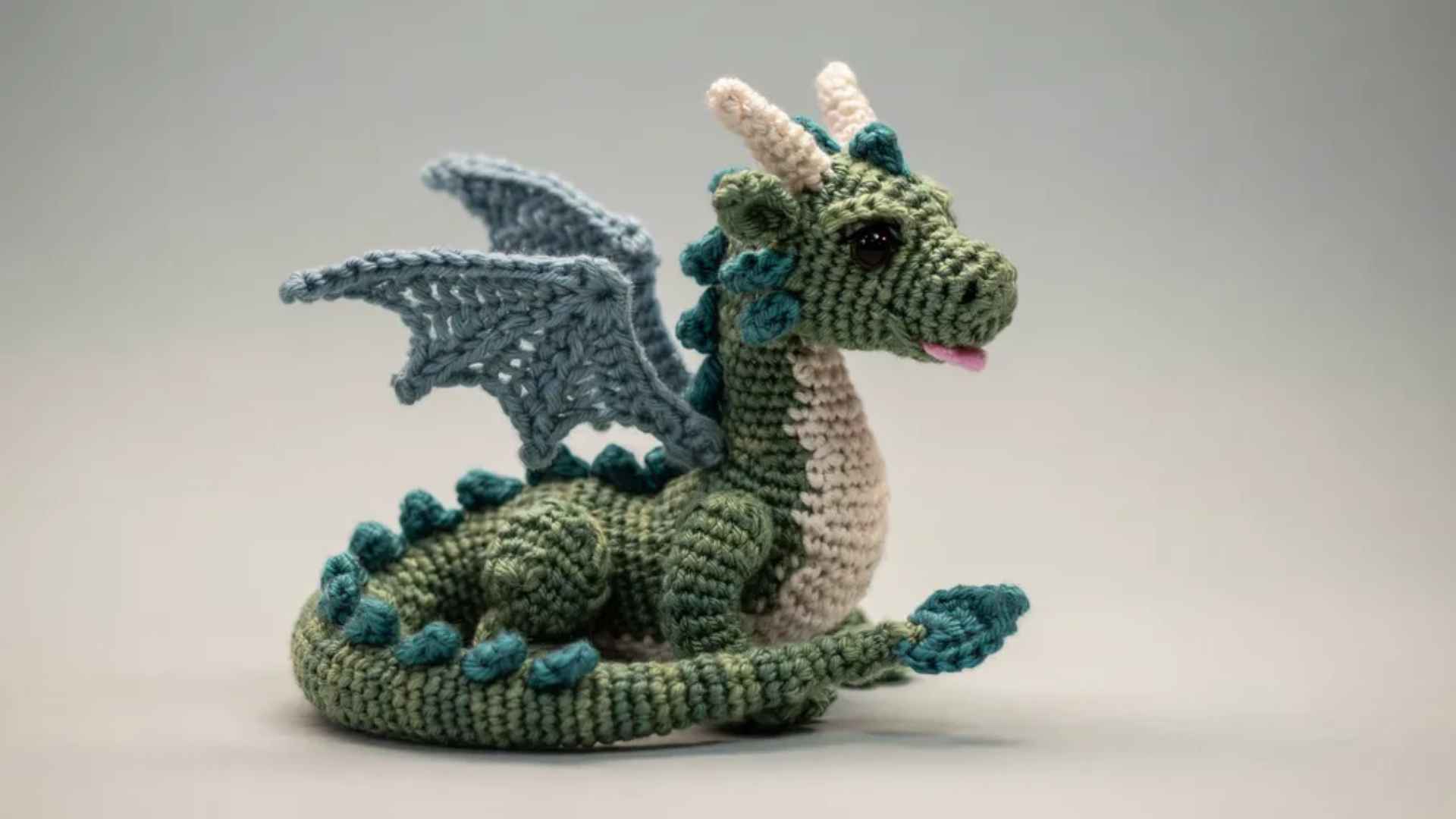 Crochet dragon amigurumi with wings and multi color details showing advanced shaping and fantasy design craftsmanship