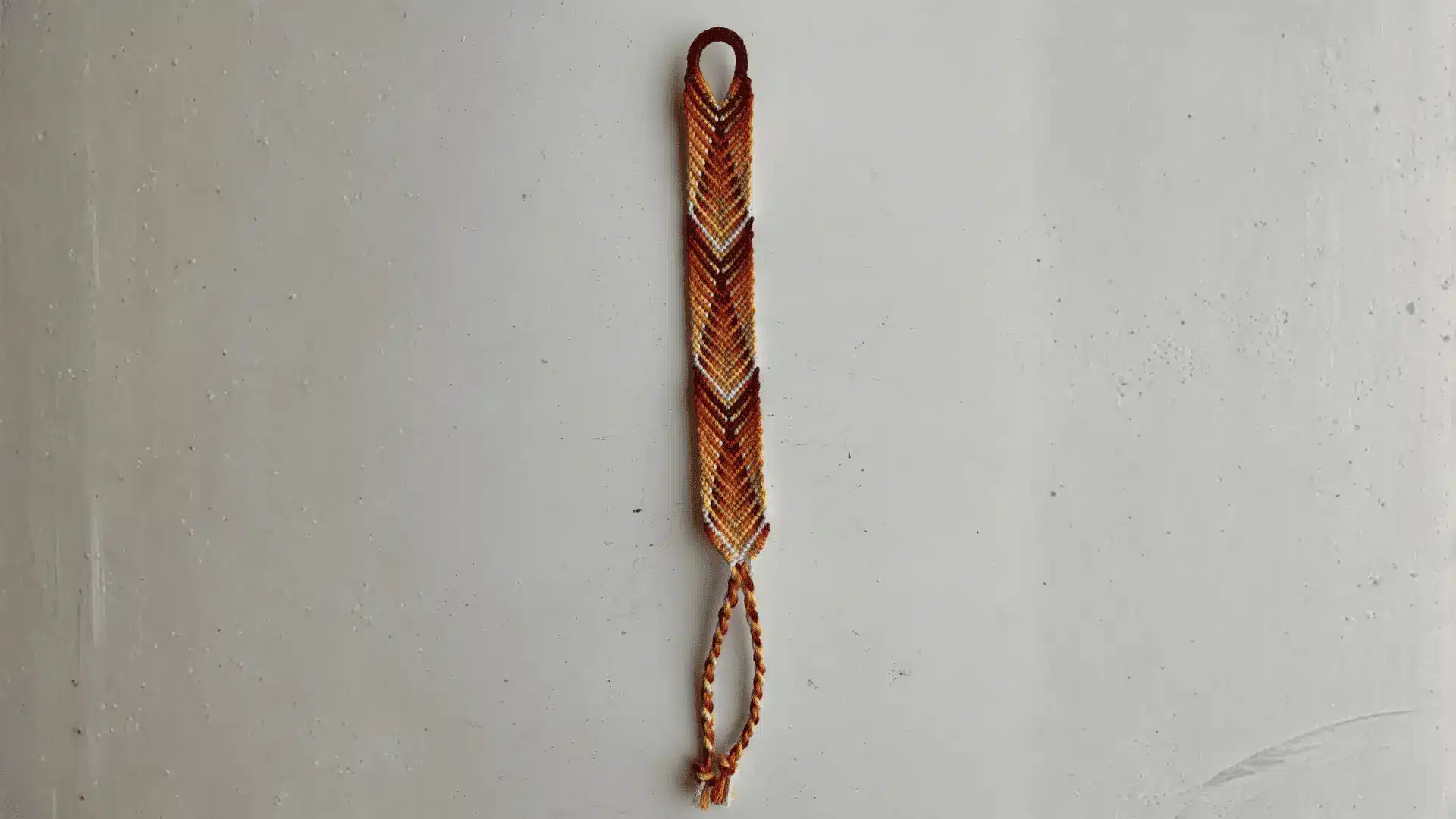 Fishbone friendship bracelet with braided center pattern.