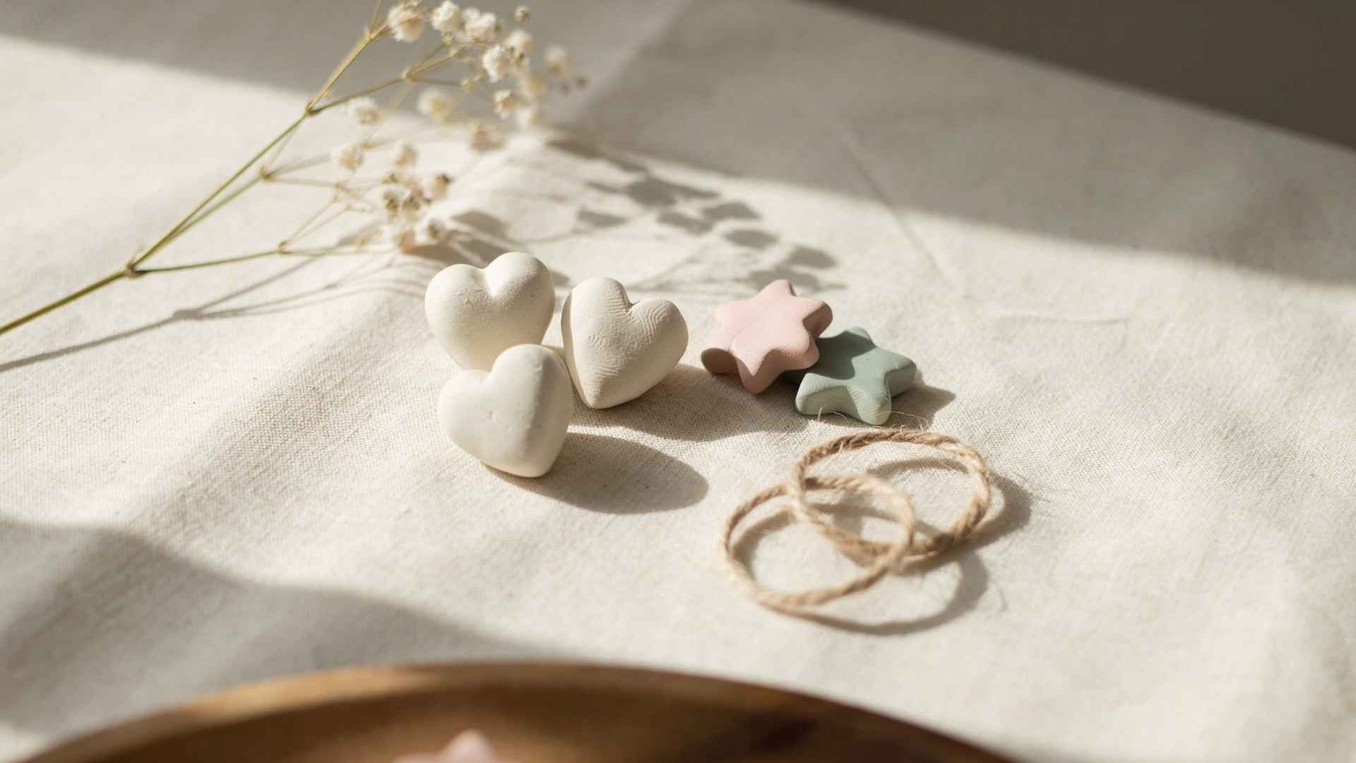 Small clay friendship charms on soft fabric surface