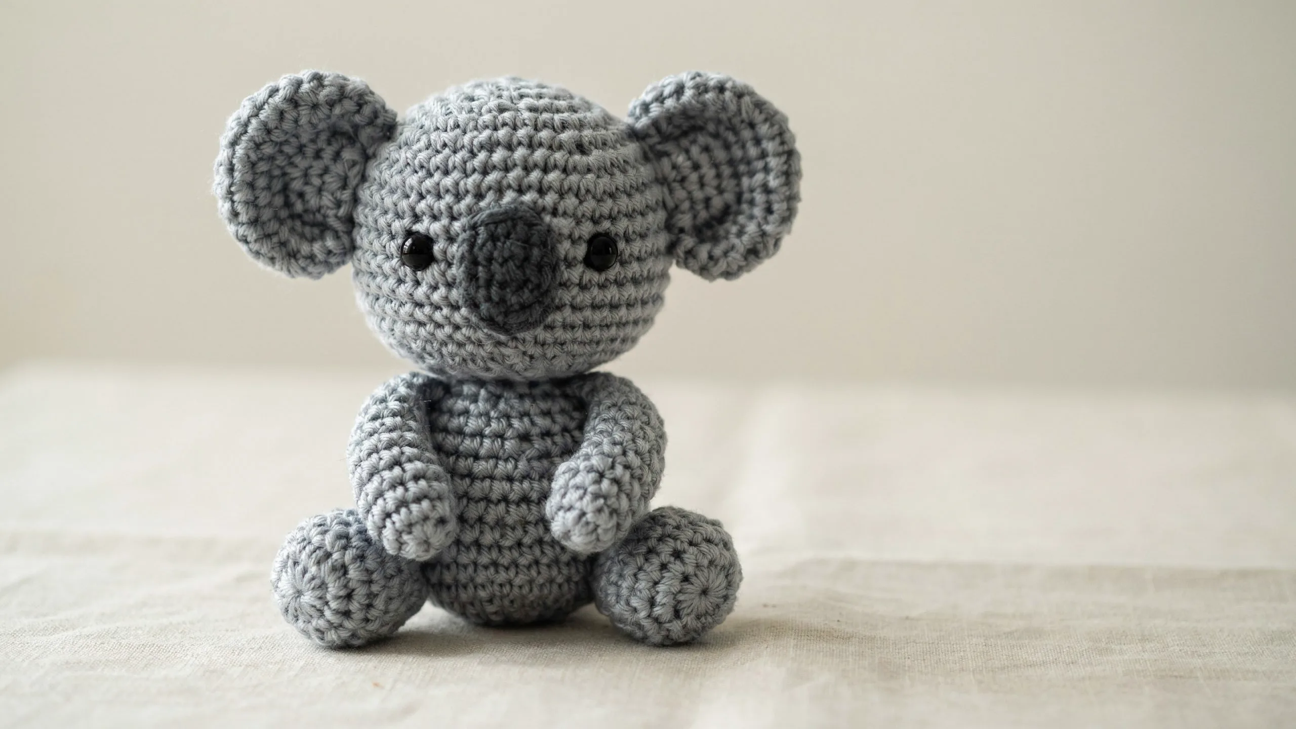 Grey crochet koala with big ears and oval nose centered
