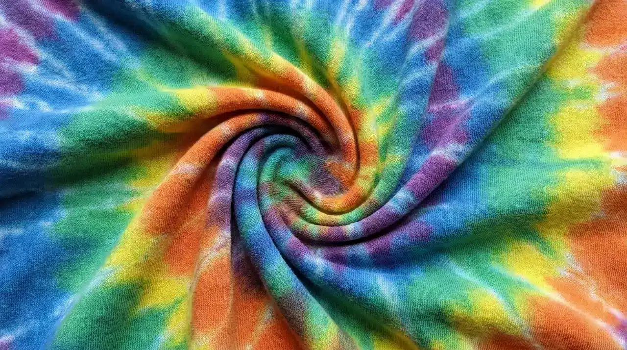 Stretchy jersey knit tie dye fabric twisted to highlight soft texture and flexibility