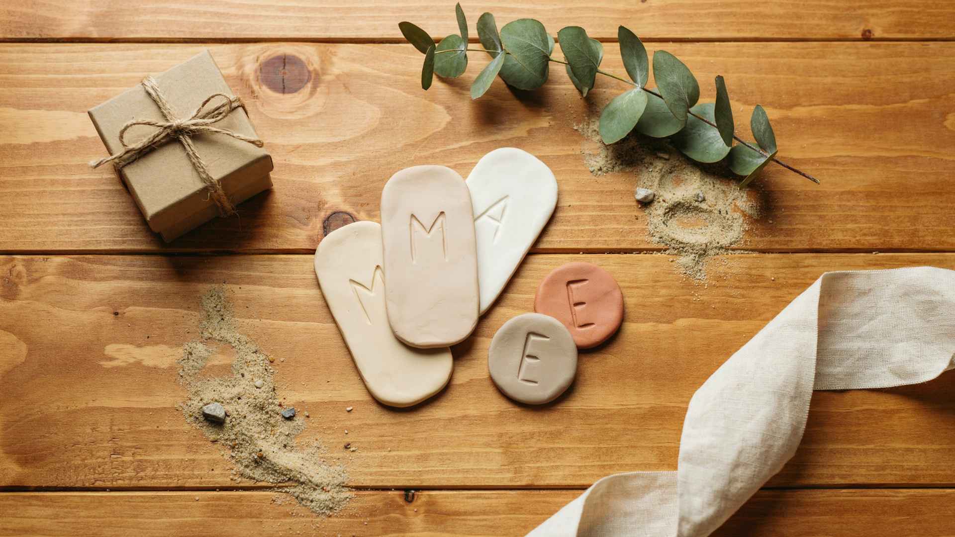 Clay name tags and initials on wooden surface decor