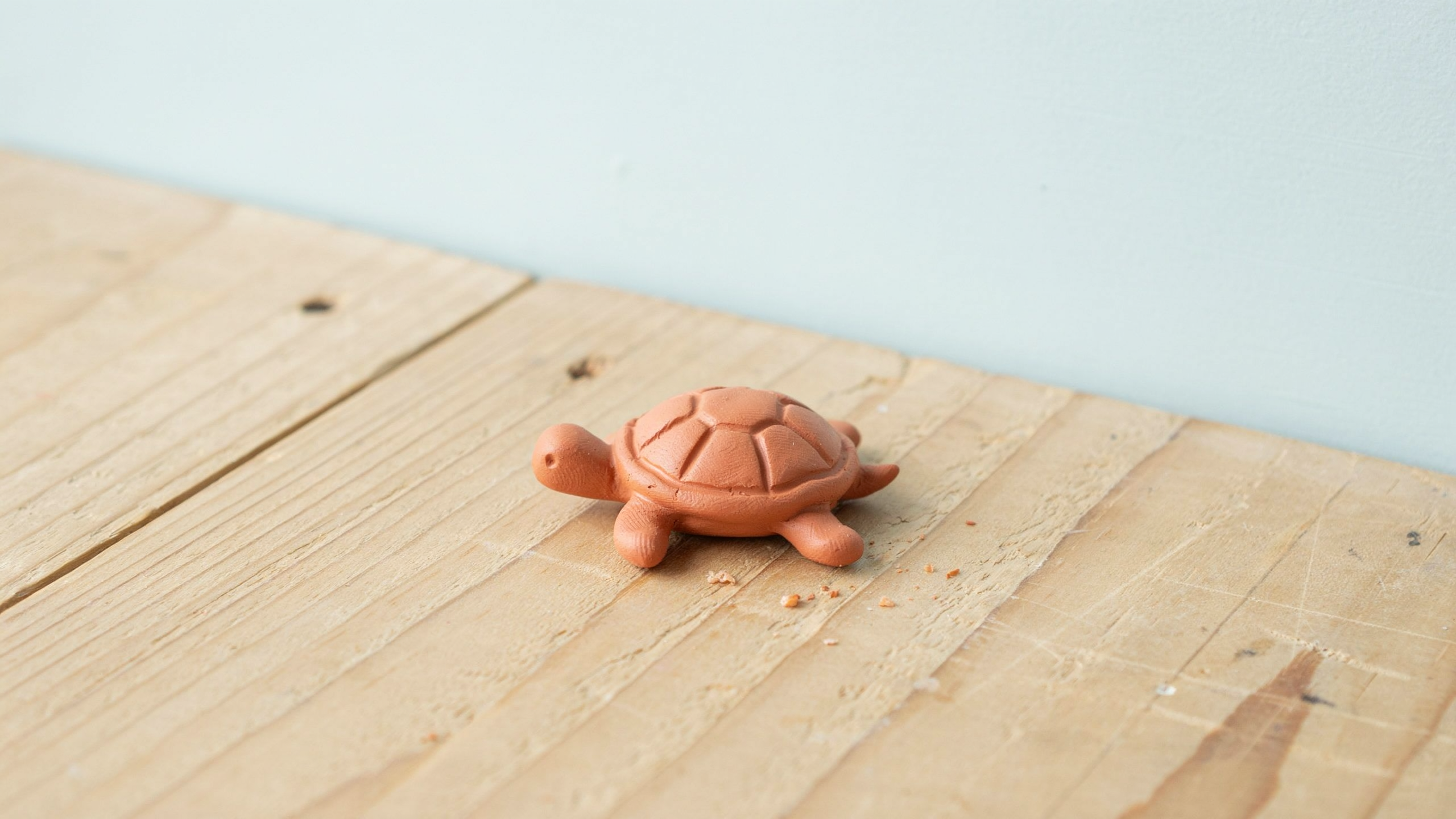 Flat handmade clay sea turtle charm featuring oval shell with textured pattern, flippers and head details arranged evenly for balanced decorative charm piece