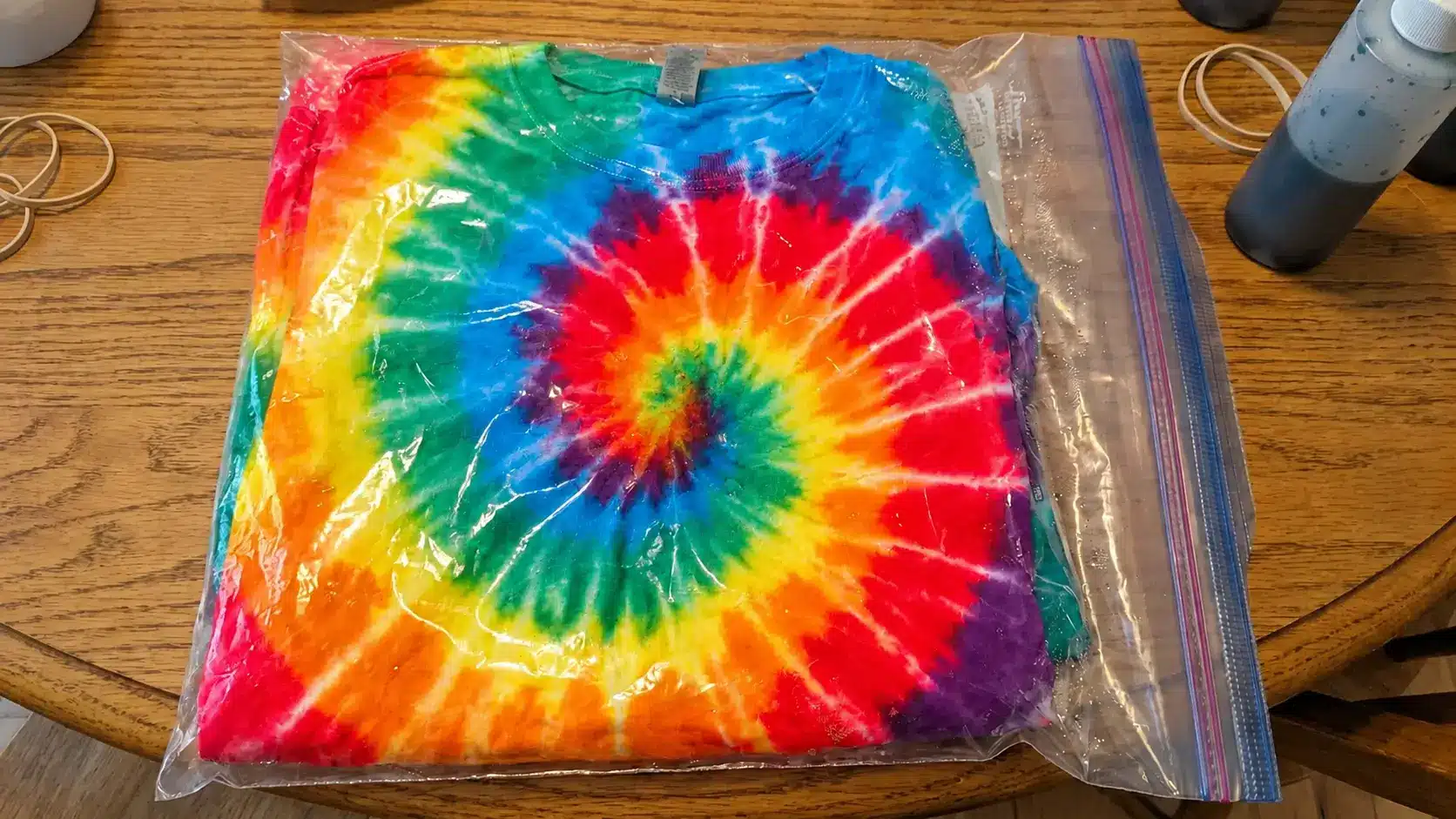 Freshly dyed tie-dye shirt sealed inside a plastic bag to allow colors to set and bond to fabric