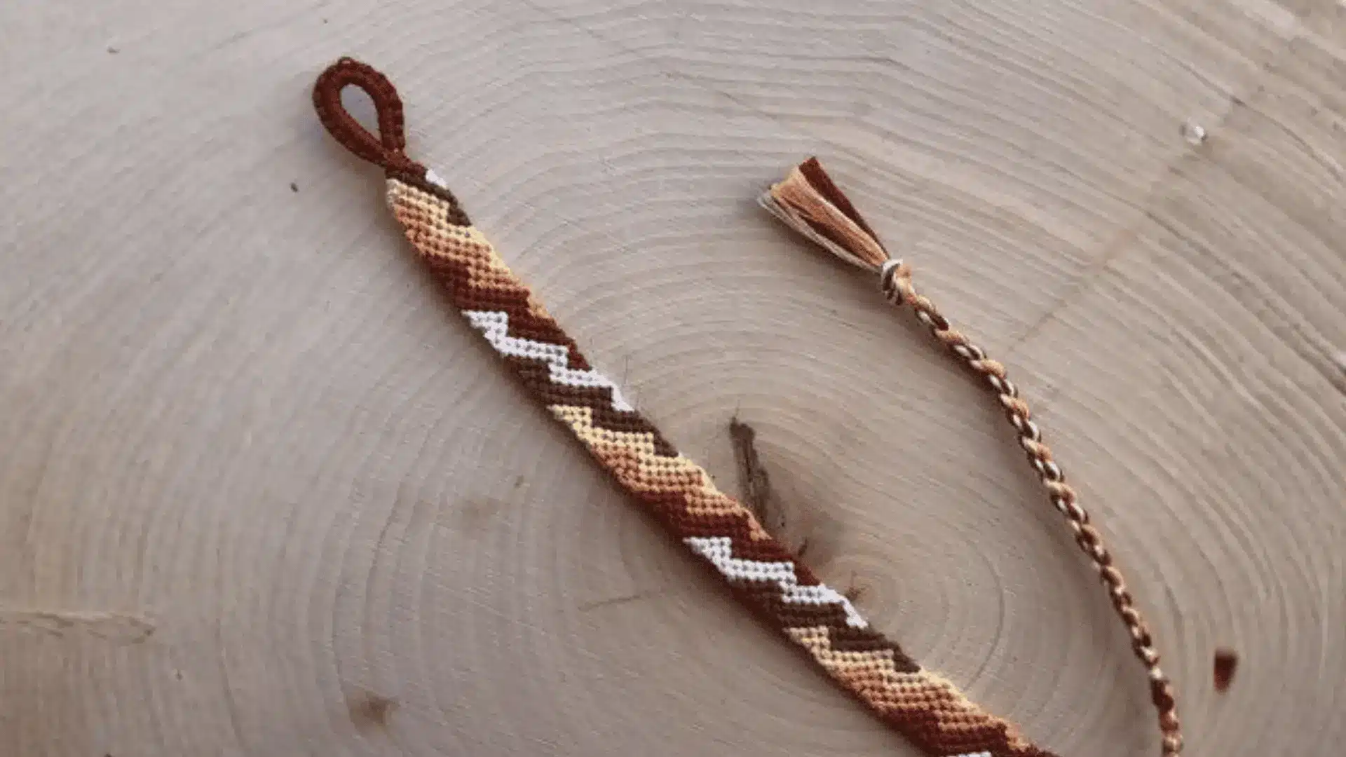 Zig-zag friendship bracelet with colorful repeating angled stripes.