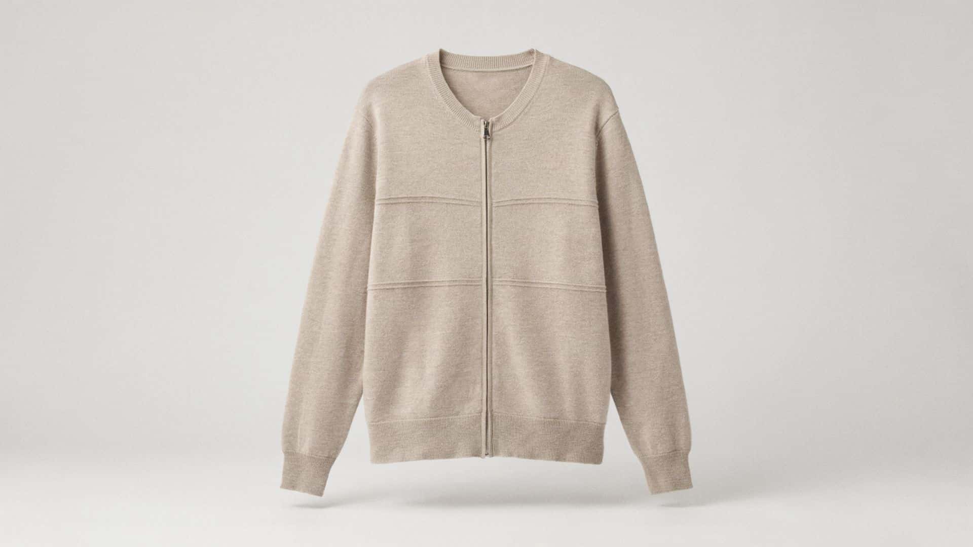 A zip-up cardigan made from soft knit material, featuring a front zipper closure, ribbed cuffs and hem, and a relaxed fit that provides warmth and comfort for casual everyday wear.