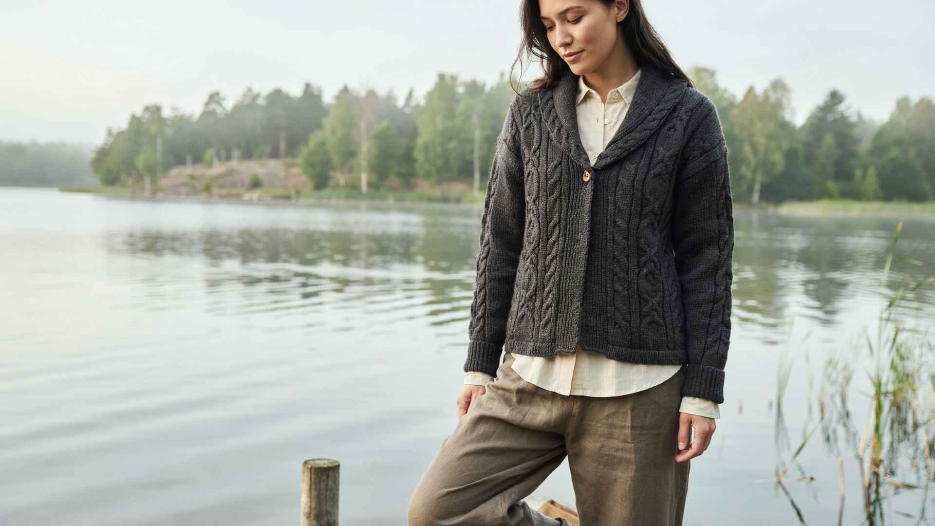 woman wearing shawl collar cardsigan in front of a lake