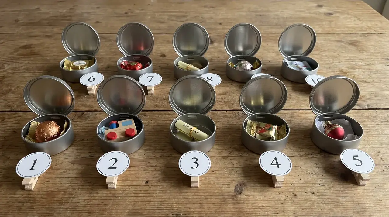 Small tins opened and numbered ready for advent calendar fillers