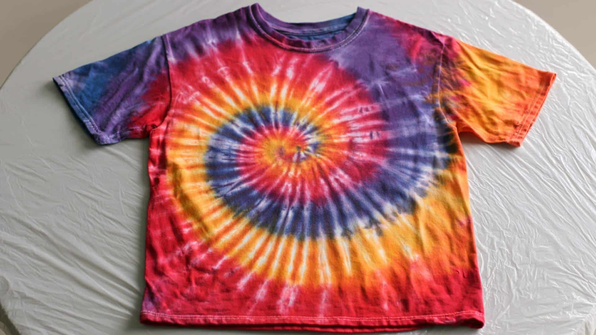 Finished spiral tie-dye shirt with vibrant red, orange, yellow, and purple colors